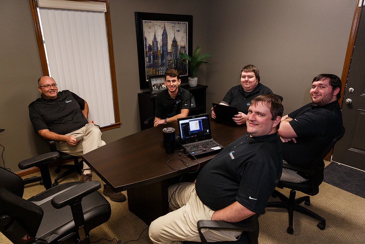 Image of four DEVsource employees sitting around a conference table